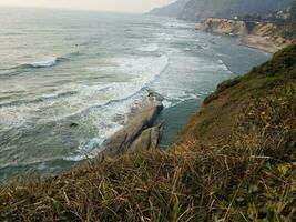 beach and ocean water with waves in Newport, Oregon photo