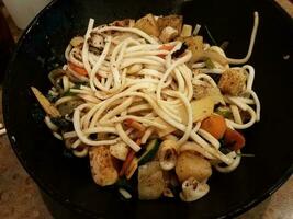 asian noodles and squid and pineapple in bowl photo