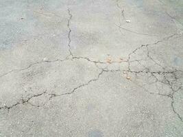 cracked or broken black asphalt or pavement photo