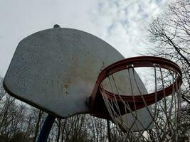 worn or weathered basketball hoop and backboard photo