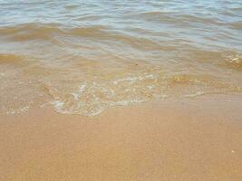 sand with waves and rocks photo