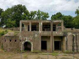 old abandoned cement building with weeds photo
