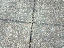 grey cement or pavement with rocks and pebbles photo