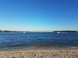 beach and water and bridge at Solomons Island Maryland with boats photo