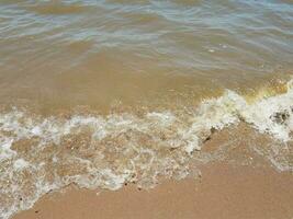 sand with waves and rocks photo