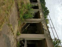 antiguo edificio de cemento abandonado con malas hierbas foto