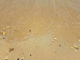 sand with waves and rocks photo