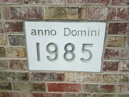 anno domini 1985 sign on brick wall photo