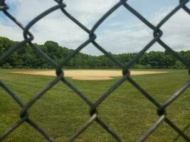 baseball diamond behind fence photo