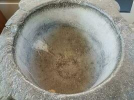 heavy grey stone baptismal font or basin for baptism photo