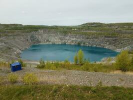 large deep blue lake where asbestos was mined in Canada photo