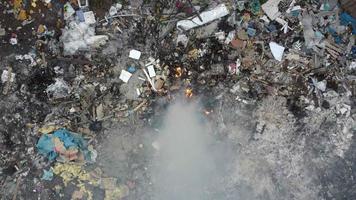 Aerial descending look down open burning of rubbish video