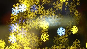 blau gelb flackerndes schneeflockenlicht in unscharfem bokeh video