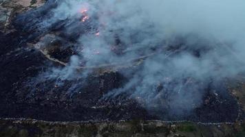 Aerial view burning happen at large part of landfill site video