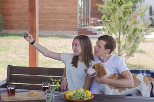 Young couple with beagle dog, happy family have good time in backyard photo