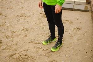 group of young people training outdoors, runners exercises, sea or river background photo