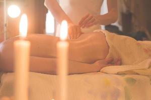 close up of massage process. Woman hands do massage in spa. photo