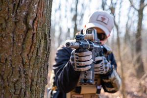 Male from private military company with rifle in the forest photo