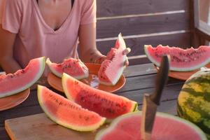 Fresh watermelon slices on wooden table, summer time colorful background photo