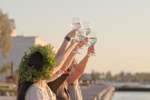 Summer party of young beautiful womans with wine, sea resort relaxing in sunny day photo