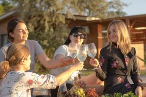 Summer party of young beautiful womans with wine, sea resort relaxing in sunny day photo