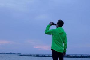 runner training in sunny day, sea background photo