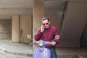 Young stylish male with colorful motor scooter photo