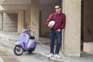 Young stylish male with colorful motor scooter photo