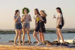 Summer party of young beautiful womans with wine, sea resort relaxing in sunny day photo