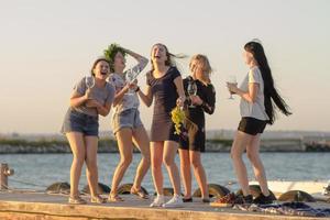 Summer party of young beautiful womans with wine, sea resort relaxing in sunny day photo