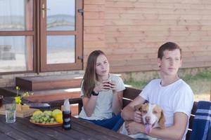 Young couple with beagle dog, happy family have good time in backyard photo