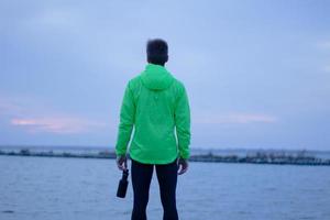 runner training in sunny day, sea background photo