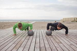 group of young people training outdoors, runners exercises, sea or river background photo