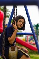 Teen girl swings Playground. photo