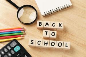 School supplies on wooden table background. Back to school concept. photo