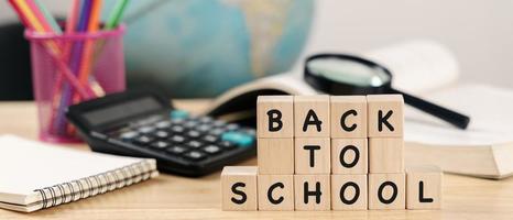 School supplies on wooden table background. Back to school concept. photo