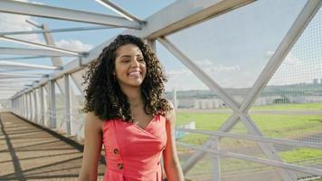 Beautiful Latin woman walking in the city. photo