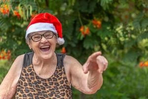 Senior woman in santa hat smilling. photo