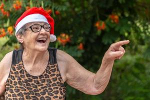 Senior woman in santa hat smilling. photo