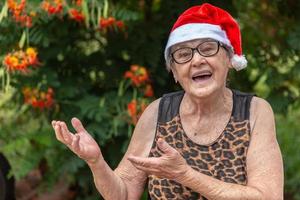 Senior woman in santa hat smilling. photo