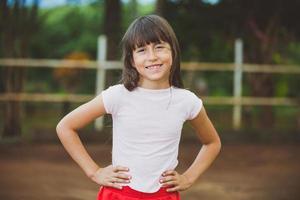 Portrait of smiling beautiful young girl at farm. Girl at farm in summer day. Gardening activity. Brazilian girl. photo