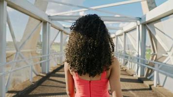 Beautiful Latin woman walking in the city. photo