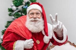 Santa Claus looking at the camera. Christmas is coming. Merry Christmas. Santa is watching photo