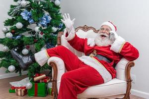 Santa Claus using a smartphone. Talking on the phone with child. Analyzing Christmas requests. photo