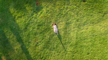 Aerial view of woman lying in meadow photo