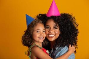 Afro daughter and mother are happy together. photo