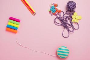 Creative flat lay of hobby time and art tools on a colorful pink background. Copy space photo