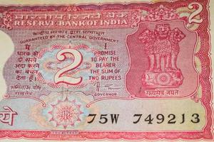 Old Two Rupee notes combined on the table, India money on the rotating table. Old Indian Currency notes on a rotating table, Indian Currency on the table photo