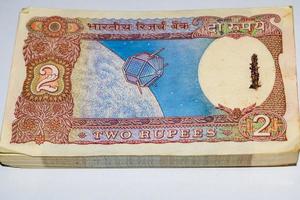 Old Two Rupee notes combined on the table, India money on the rotating table. Old Indian Currency notes on a rotating table, Indian Currency on the table photo