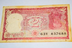 Old Two Rupee notes combined on the table, India money on the rotating table. Old Indian Currency notes on a rotating table, Indian Currency on the table photo